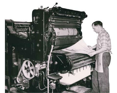 Man working at 1960's printing press.