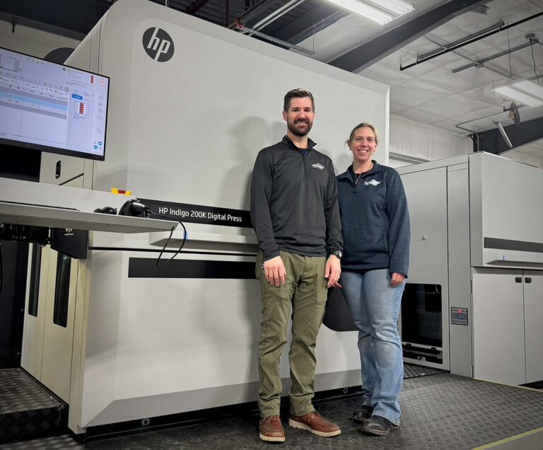 CastlePierce team members standing in front of packaging printing equipment.